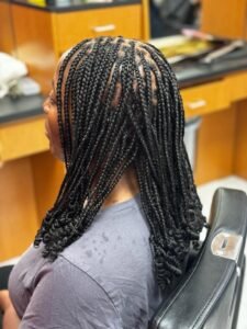 black shoulder length braids with spiral curls ends